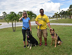 RANGER 1 AND HIS NEW MOM LORI, DAD ERIC AND BROTHER DOG 717
